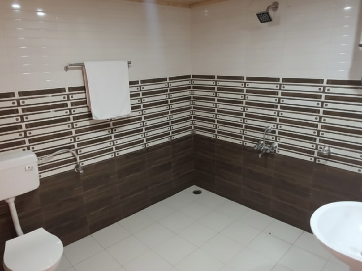 Clean tiled bathroom with hot-water shower