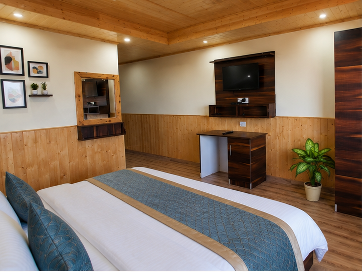 Wooden desk, wardrobe and TV inside a deluxe room